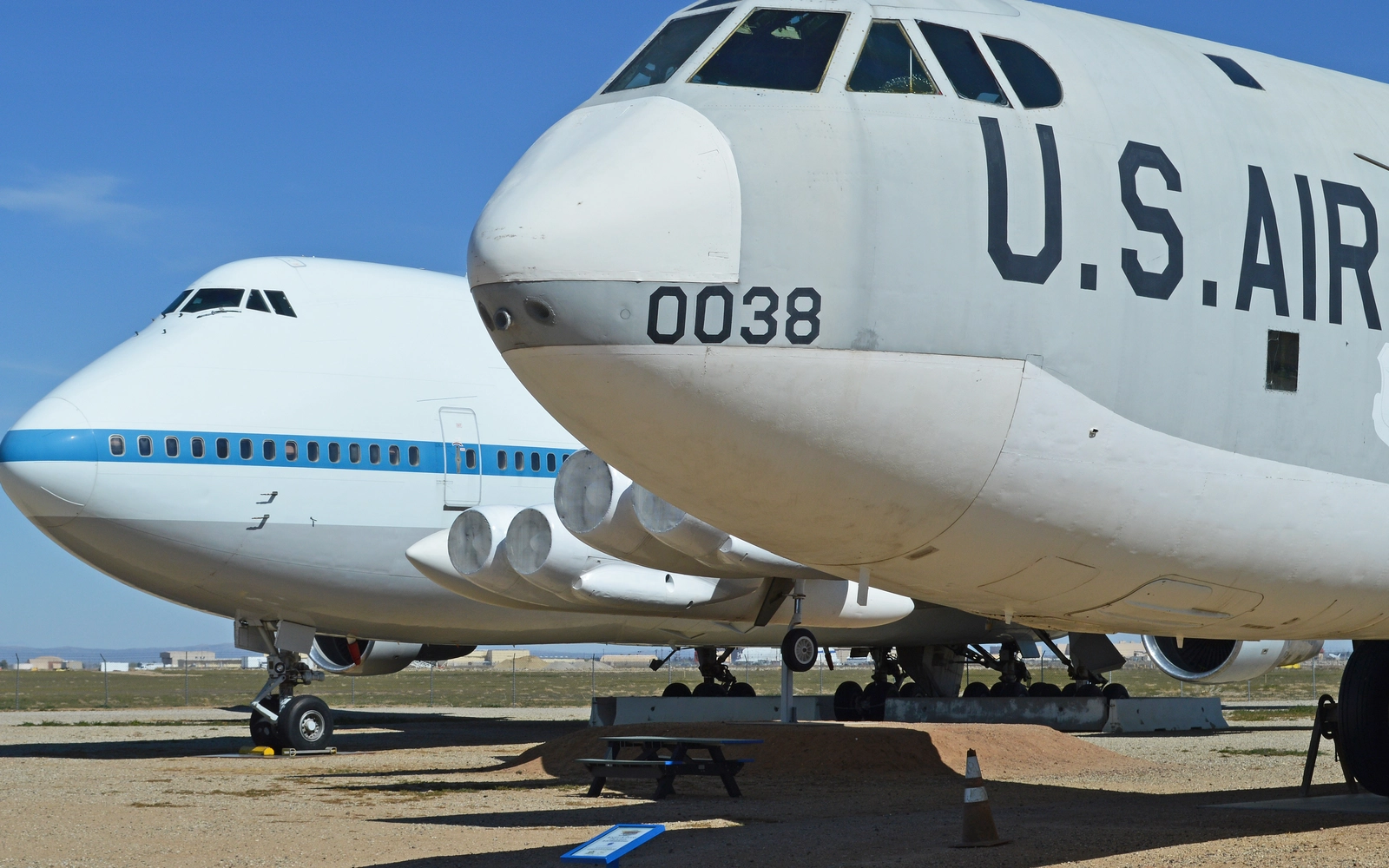 A B-52F and the NASA 747 N911NA parked on the ground at the Joe Davies Heritage Airpark in Palmdale, with an interpretive sign between them